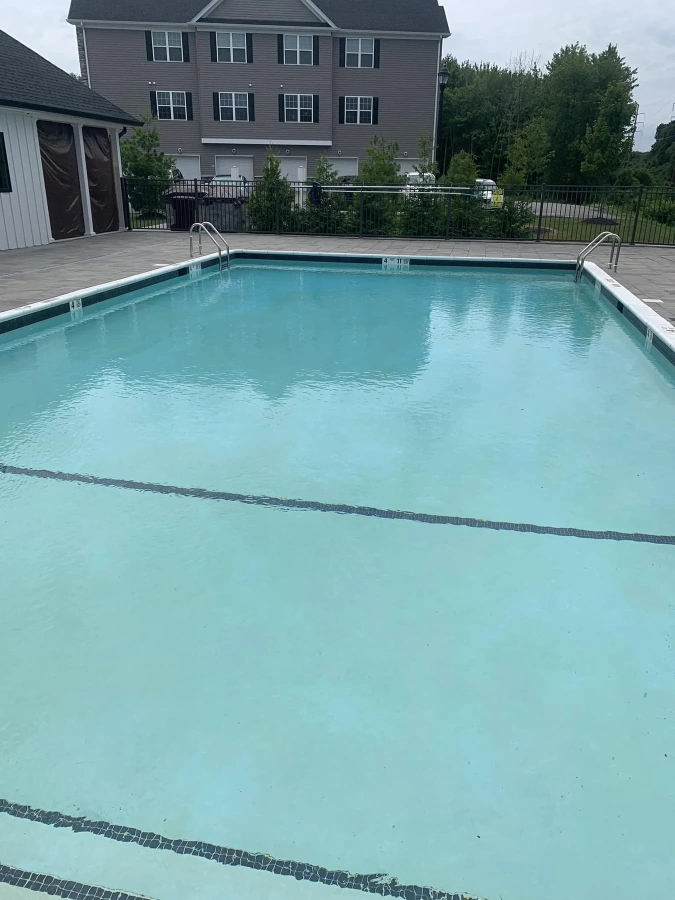 Clean outdoor swimming pool maintained by Koby Pools