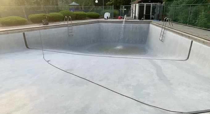 Drained swimming pool during seasonal preparation work