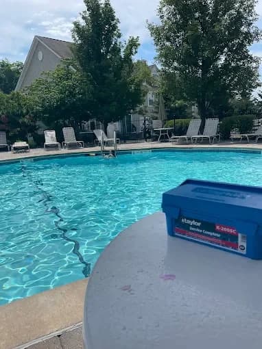 Pool service equipment beside clear swimming pool water